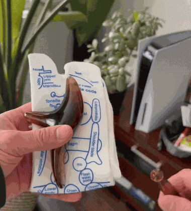 Using the gua sha pressure tool on the mapped sock